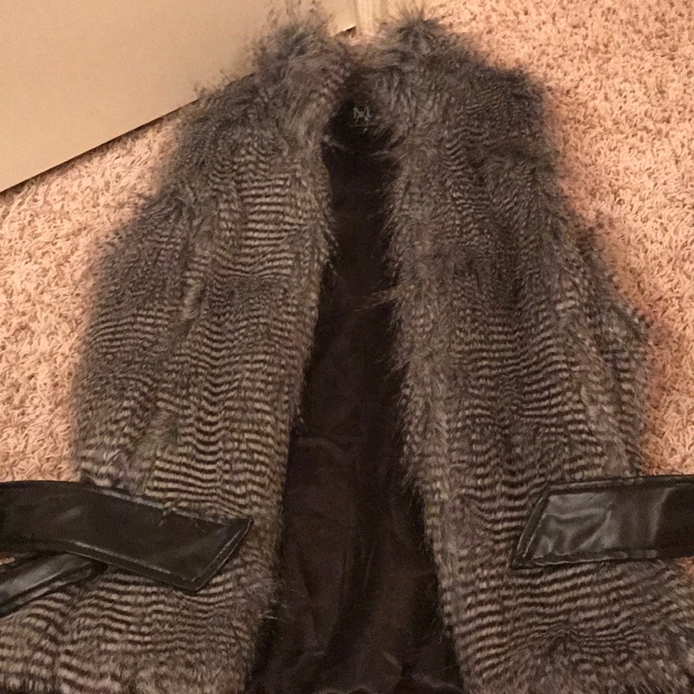 I’m selling a black and white fur vest!